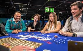 Mobile phone displaying the oriontoto login app interface with account dashboard and live-dealer table lobby